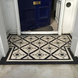 Victorian tiling in front of a blue front doors