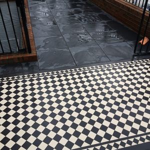 combination of victorian black and white tiles with black modern tiles
