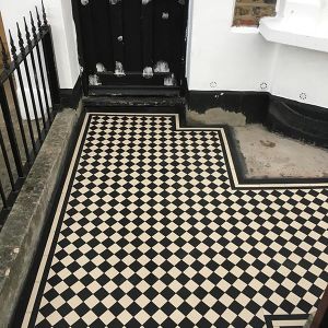 victorian black and white floor tiles on the outside of a house