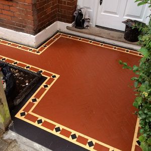 distinctive black and brown victorian pathway in the traditional brick house