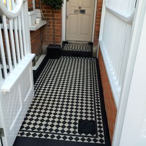 victorian black and white floor tiles London leading from the gate to the front door of a brick house