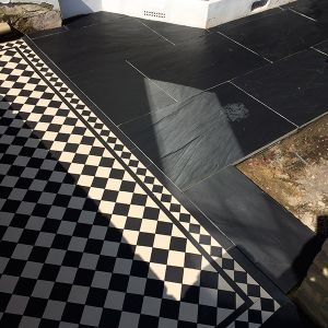 combination of victorian black and white tiles London with black modern tiles